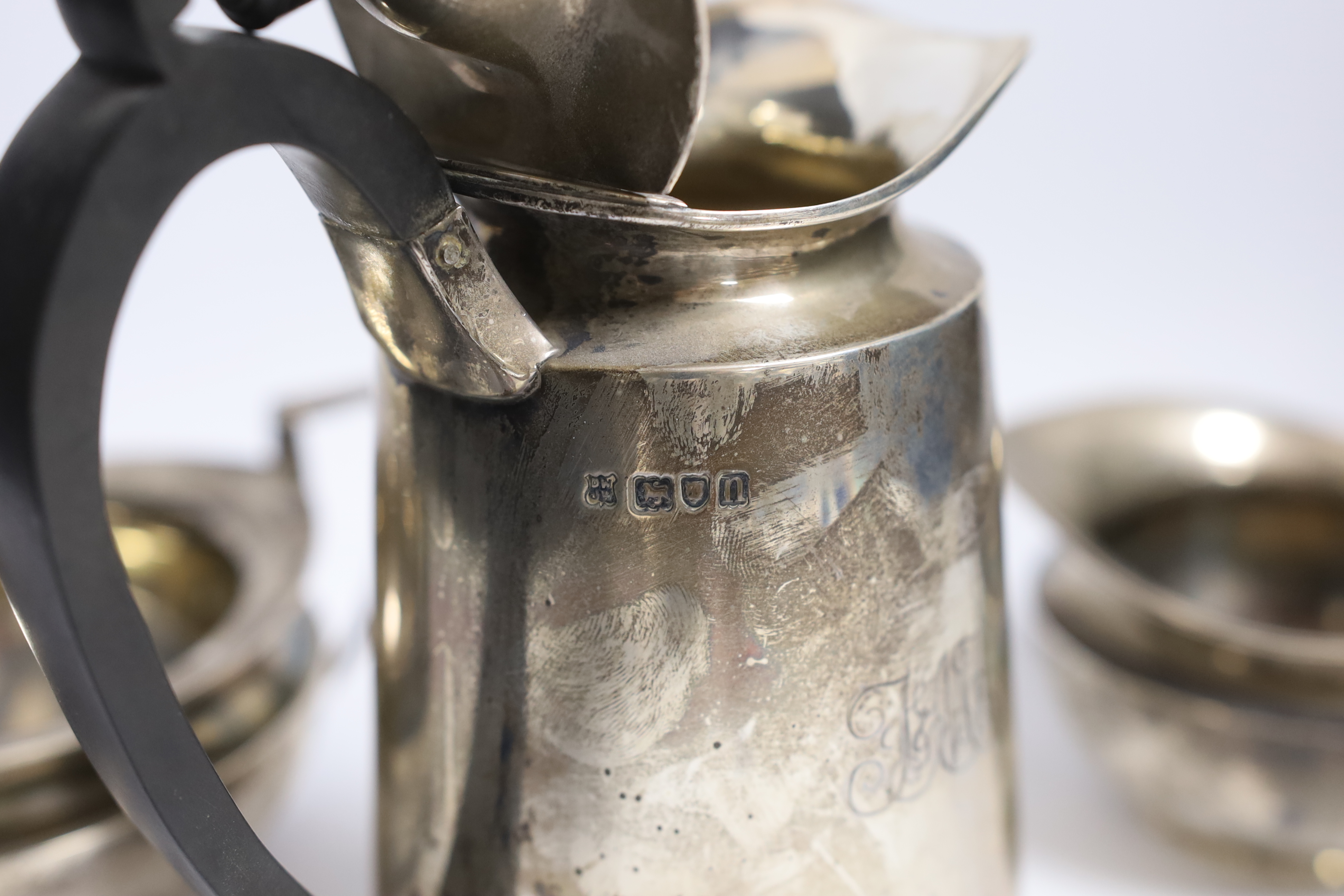 An Edwardian silver hot water pot and matching sugar bowl and cream jug, Daniel & John Welby, London, 1908/9, gross weight 45oz.